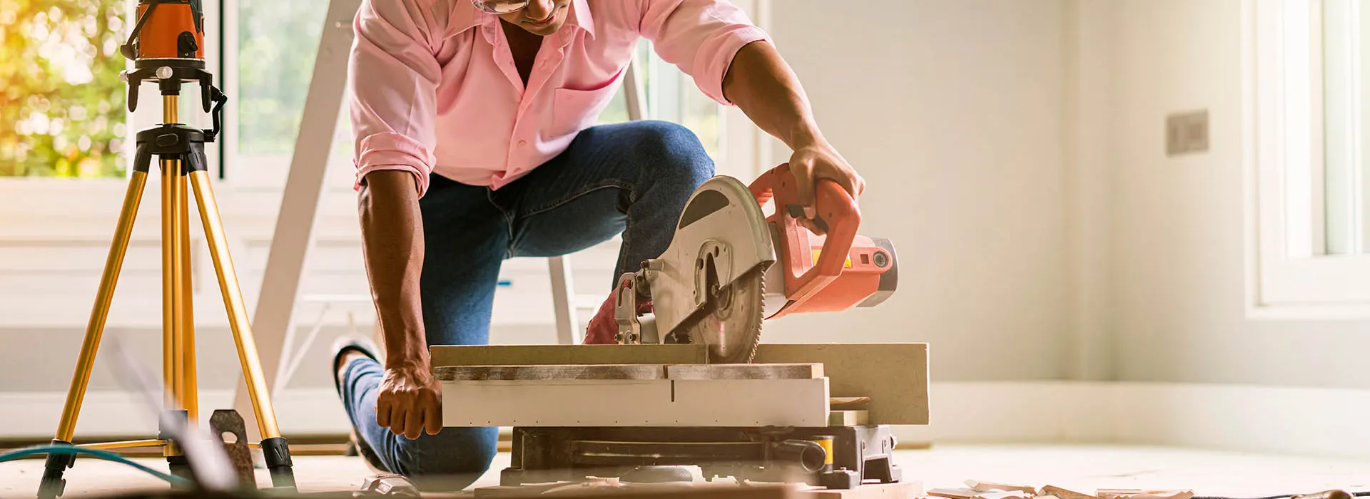 DIY man cutting floorboards 
